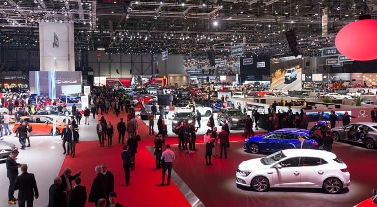 Panoramic photo of a trade show with a white car on display
