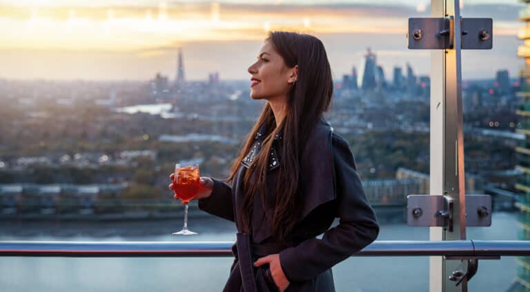 businesswoman in a London rooftop bar after work