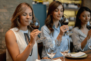 Three women taking part in a wine event